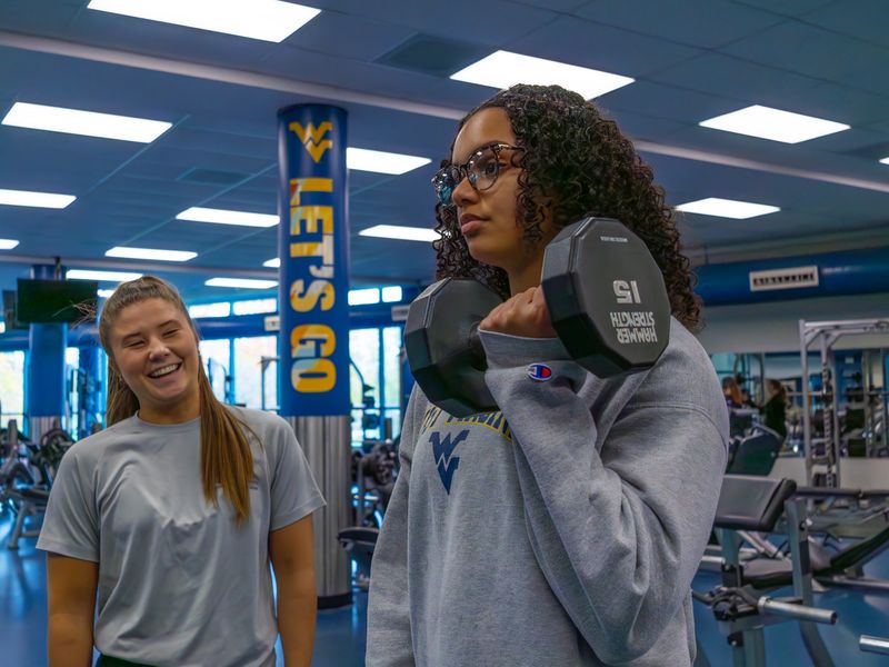 Ladies lifting weights in Student Rec Center