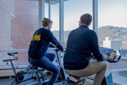 Students utilizing the bikes of the Active Workspaces in the downtown WVU Library.