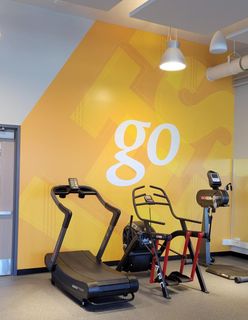 Downtown Fitness Center graphics Go Wall near fitness equipment
