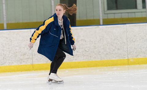 a girl figure skating in a rink