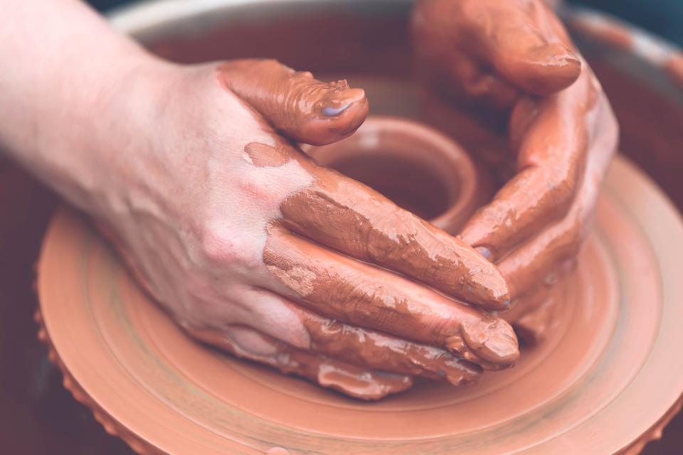 A close up of a person creating ceramics.