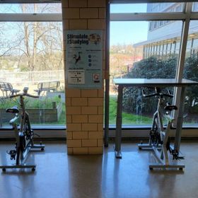 Two bikes and one desk near windows of Activity Center WVU Health Sciences Center